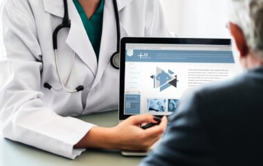 doctor pointing at tablet laptop