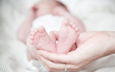 close up of hands holding baby feet