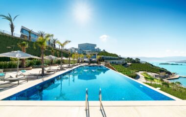 parasol and lounger chair near swimming pool