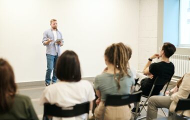 man wearing gray dress shirt and blue jeans