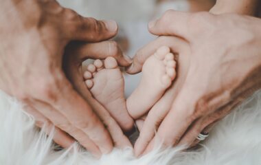 person holding baby s feet