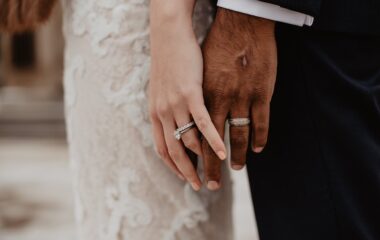 two persons wearing silver colored rings