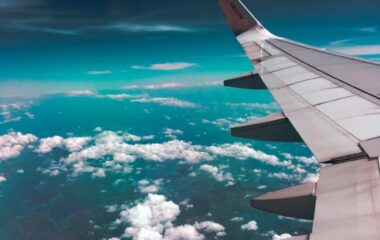 airplane wing towards clouds