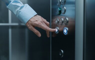 close up shot of a hand pressing an elevator button