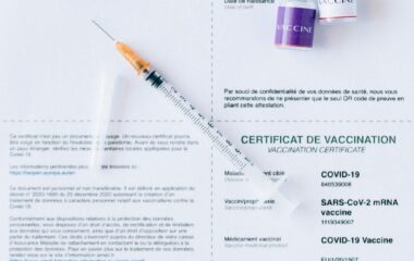 syringe on covid document