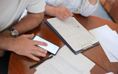 person in white button up shirt holding white paper